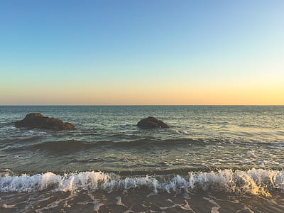 sea waves near black rocks thumbnail