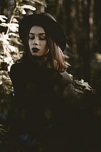 woman looking down in the forest thumbnail