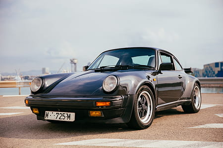 Side view of a black sports car with single door thumbnail