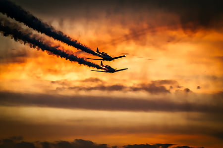 two airplanes flying in the air during sunset thumbnail
