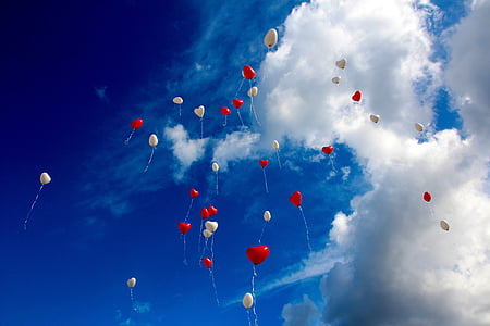 white and red heart balloons floating on sky thumbnail