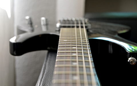 closeup photo of black stratocaster electric guitar thumbnail
