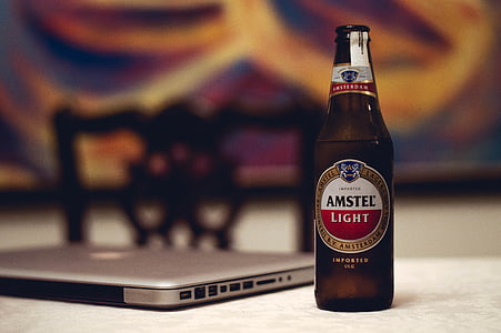 Amstel Light beer beside MacBook thumbnail