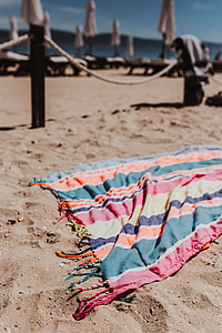 Colorful beach towel on the sand thumbnail