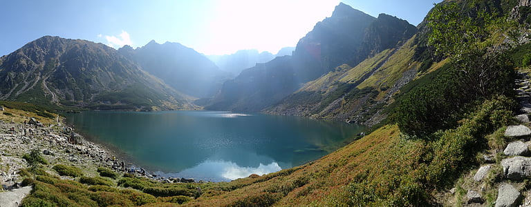 body of water surrounded by mountain thumbnail