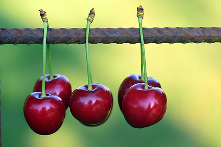 shallow focus photography red cherry on black steel bar thumbnail