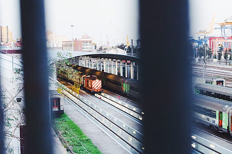 gray and red trains during daytime thumbnail