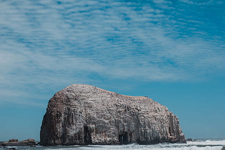 Gray Rock Formation on Beach Under Blue Sky thumbnail
