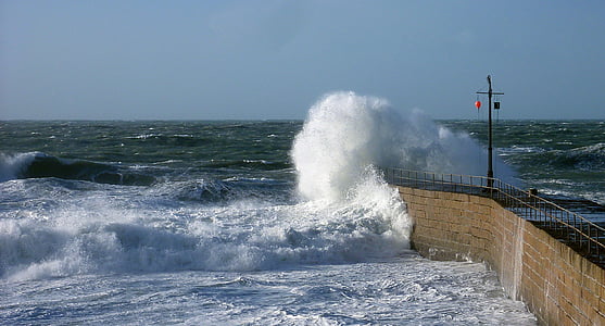 ocean waves near brown concrete dock at daytime thumbnail
