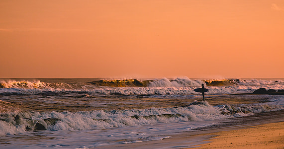 person standing on sea waves thumbnail