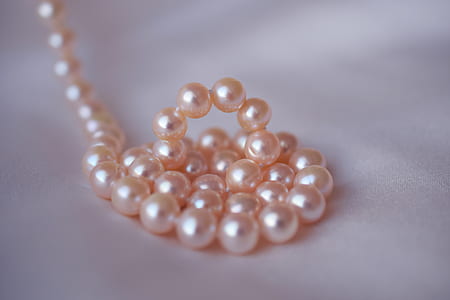 beaded pink pearl jewelry on white textile thumbnail