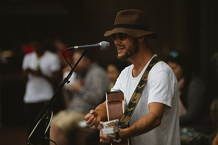 man playing guitar near black microphone thumbnail