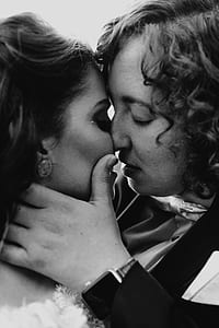 grayscale photo of kissing woman and man thumbnail
