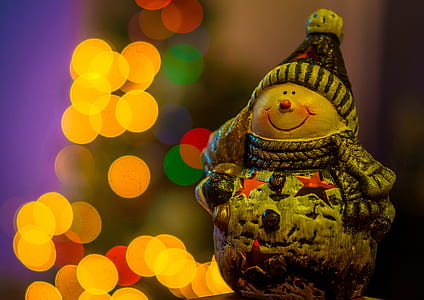 snowman figurine with bokeh light effects photo thumbnail