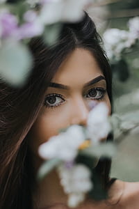 woman taking a selfie with flowers background thumbnail