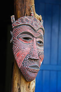 red and black tribal mask hanged on pole thumbnail