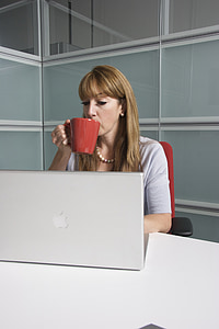 woman holding mug in front of laptop thumbnail