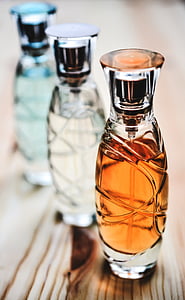 three glass bottles on table thumbnail