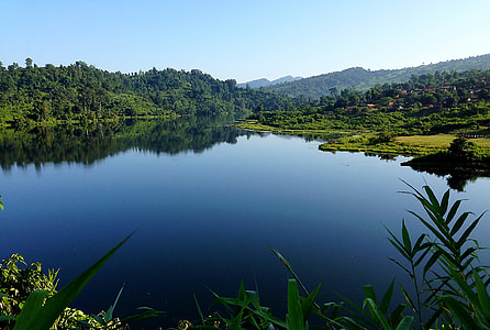 hill and lake under blue sky during daytime thumbnail