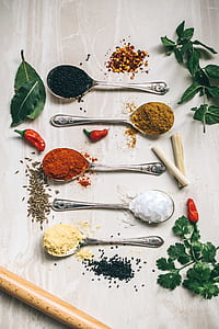 flat lay photography of spoons filled with spice powders on furniture board thumbnail
