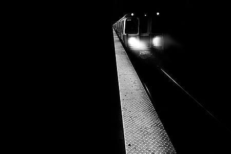 grayscale photo of train at night time thumbnail