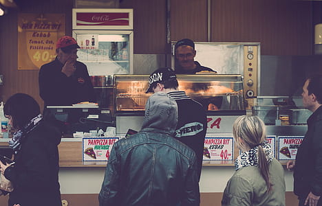people standing in front of food stall thumbnail