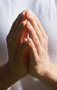 person wearing white top praying thumbnail