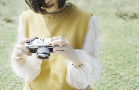 woman looking thru SLR camera thumbnail