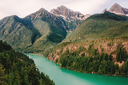 aerial photo of mountain beside body of water thumbnail