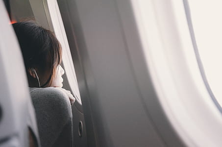 woman looking at airplane window thumbnail