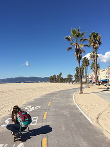 woman riding skateboard on gray pavement thumbnail