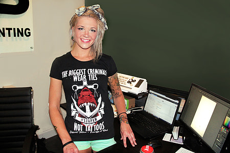 woman wearing black crew-neck shirt and green hotshort standing near in desktop computer set thumbnail