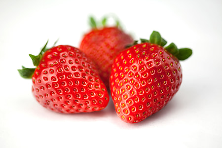 Close-up macro shot of fresh strawberries on a white background, image captured with a Canon 5D thumbnail