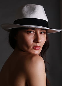 woman wearing black and white pedora hat thumbnail