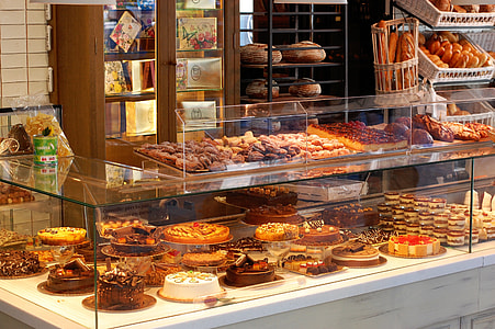 assorted cakes and breads in clear glass food display thumbnail