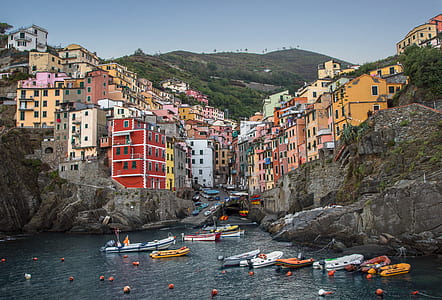 white, red, and yellow houses near on body of water thumbnail