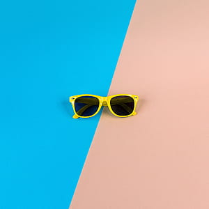 yellow sunglasses on brown surface thumbnail