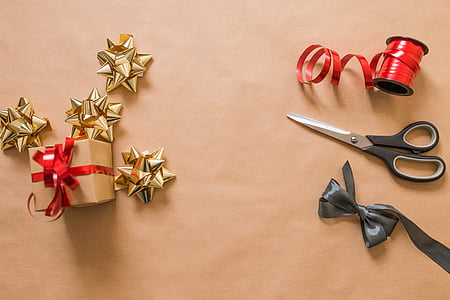 black handled scissors on brown wooden surface thumbnail