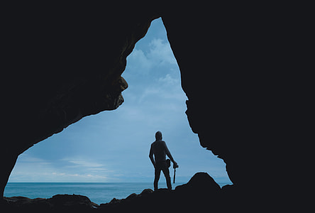 silhouette photo of man standing on rock formation thumbnail