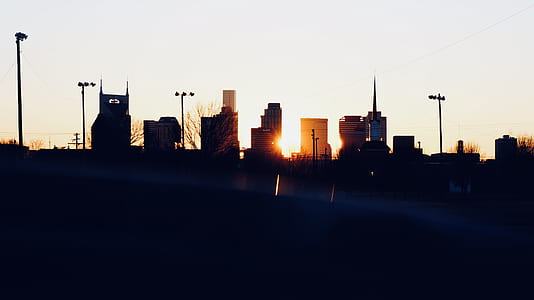 silhouette of city buildings golden hour photography thumbnail