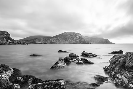 rock formation on body of water thumbnail