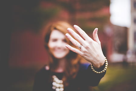 person in black showing her hand with ring thumbnail