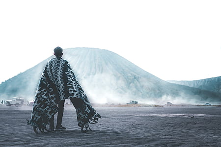 man wearing scarf walking on field thumbnail