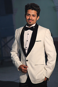 man wearing white dress coat and black dress pants thumbnail