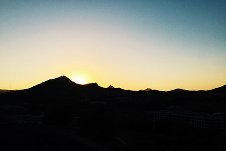 silhouette photography of sunrise covered with mountain thumbnail