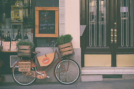 brown bicycle leaning on wall thumbnail
