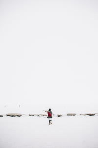 Woman Walking on Snow-covered Field thumbnail