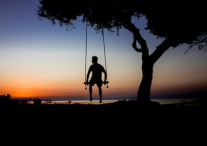 silhouette photography of person on swing thumbnail