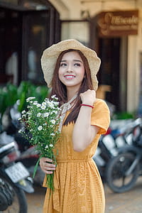Selective Focus Photo Of A Woman Holding Flowers thumbnail