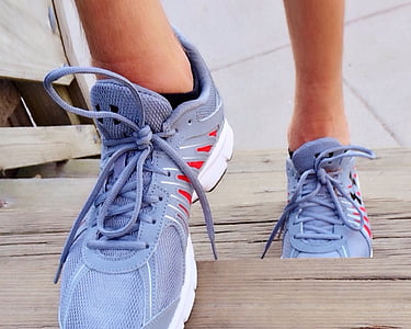 person wearing gray-and-red running shoes stepping on stairway thumbnail